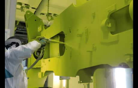 Worker painting with air gun