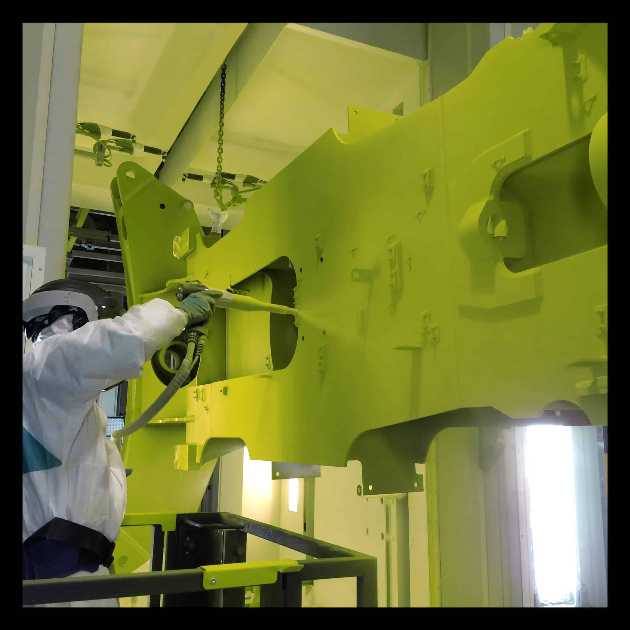 Worker painting with air gun