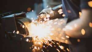 Grinding,Steel,With,Lot,Of,Sparks,By,Worker,In,Factory Grinding