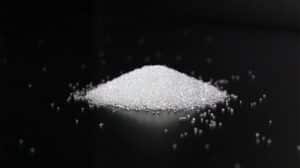 Small mound of white blasting media