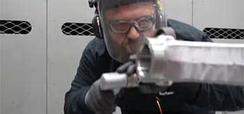 Production services man hand finishing parts