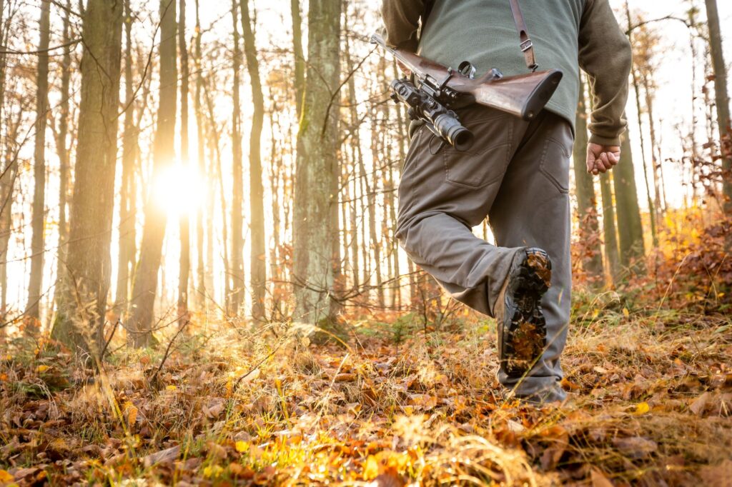 Man Hunting with Rifle in the woods